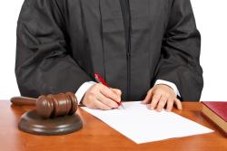 Judge Signing a Plea Bargain
